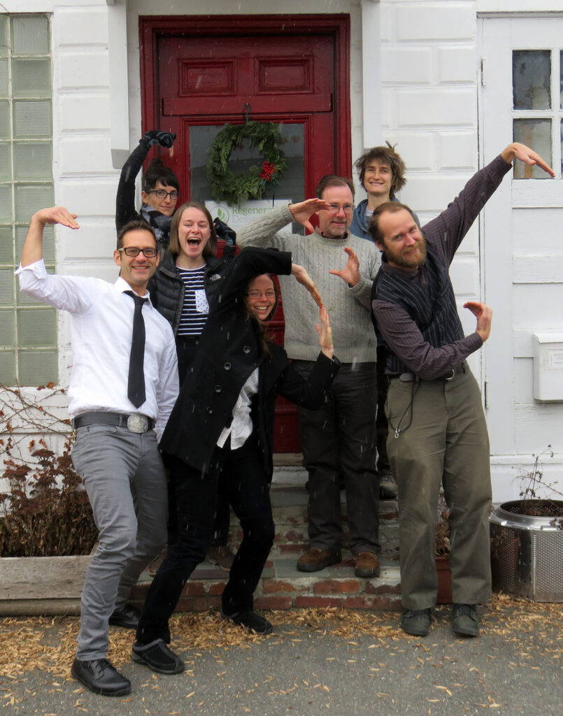 RDG team members celebrate outside the Greenfield office, posing playfully in the snow.